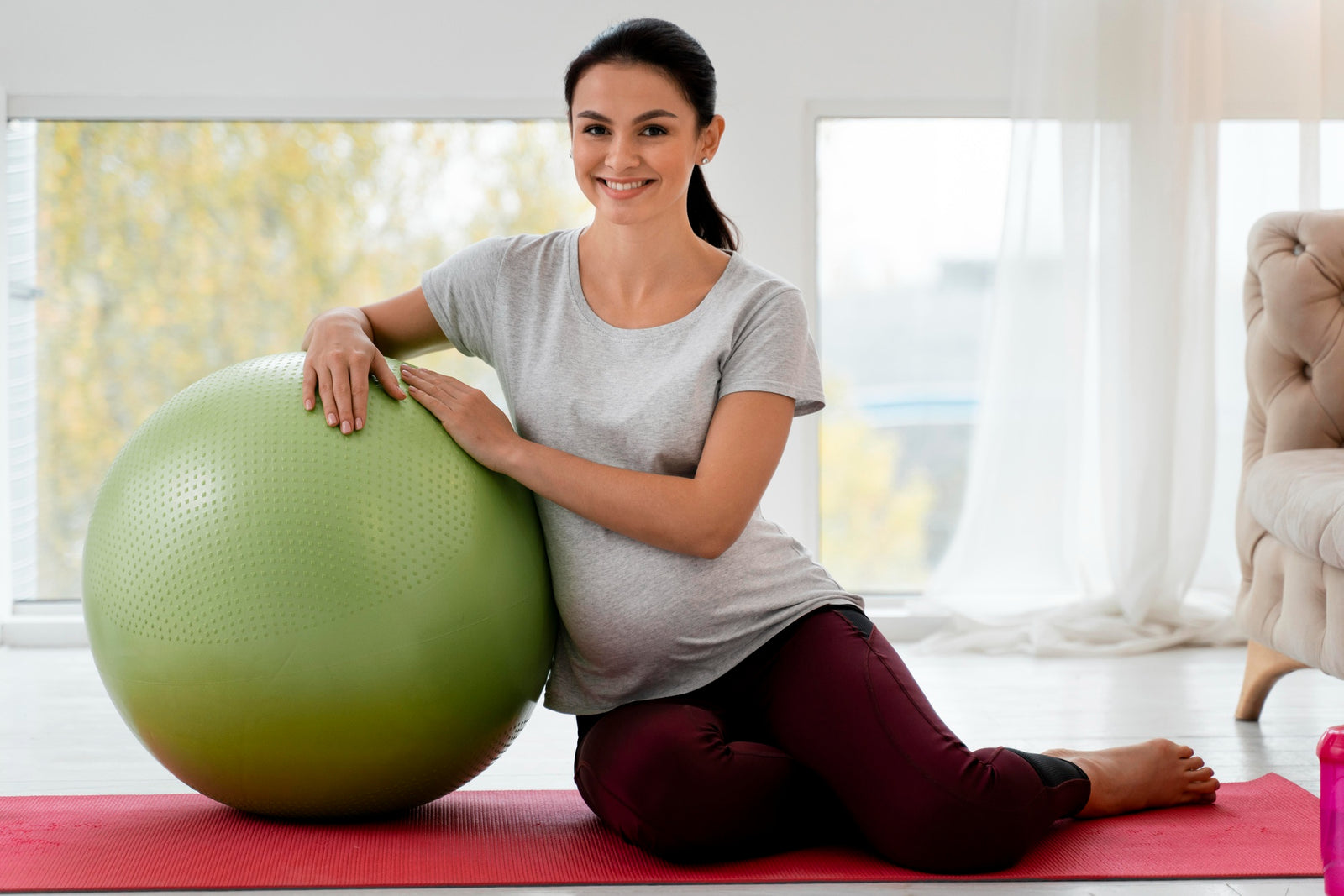 Pregnant woman exercising with fitness ball