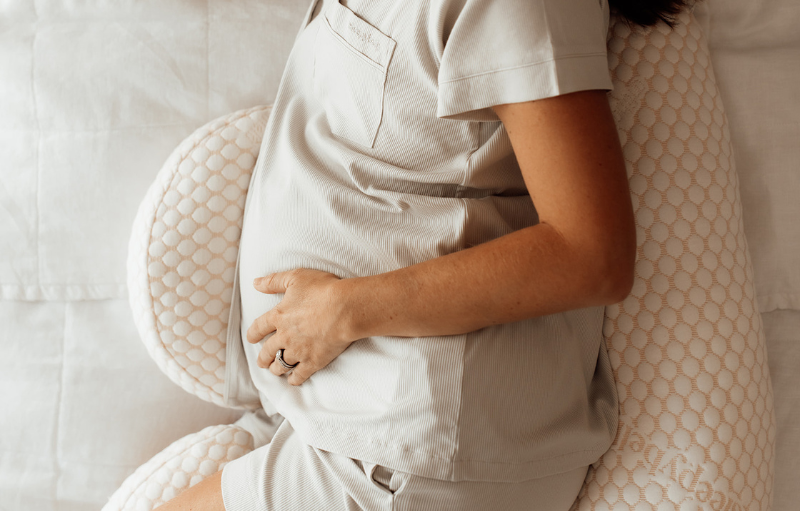 Pregnant women sleeping on pregnancy pillow 