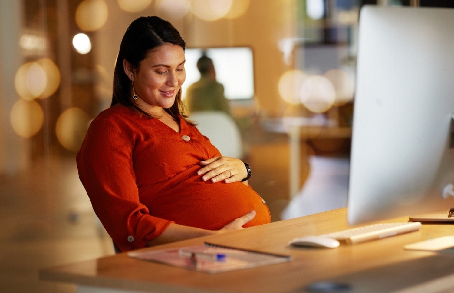 Pregnant women touching her belly gently